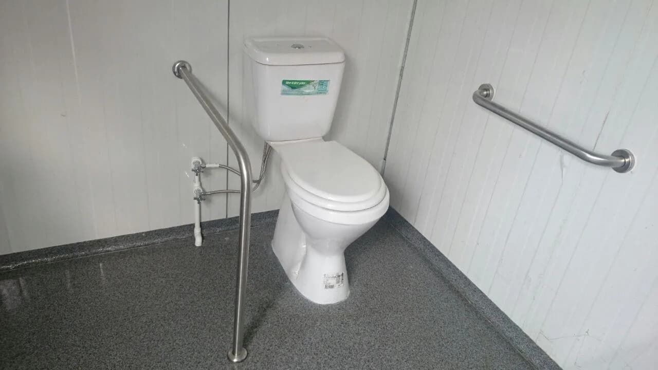 Accessible modular washroom toilet with stainless steel grab bars