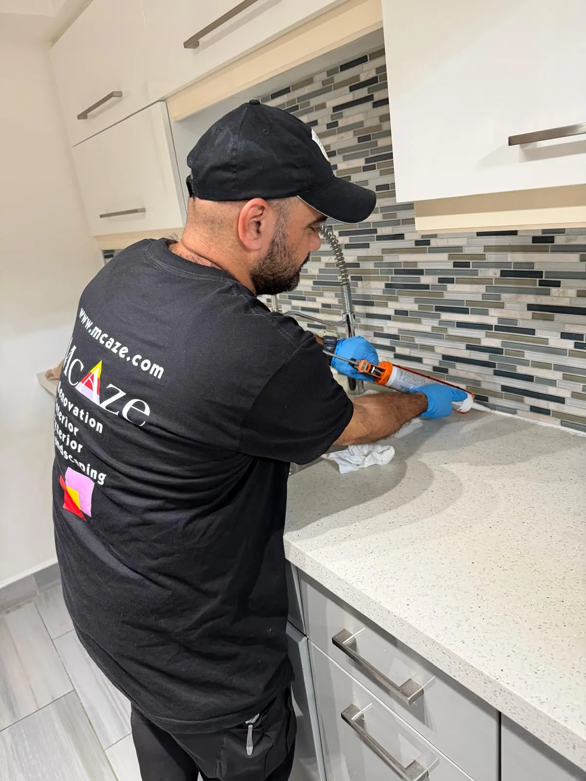 Silicone finishing along quartz countertop in North York condo