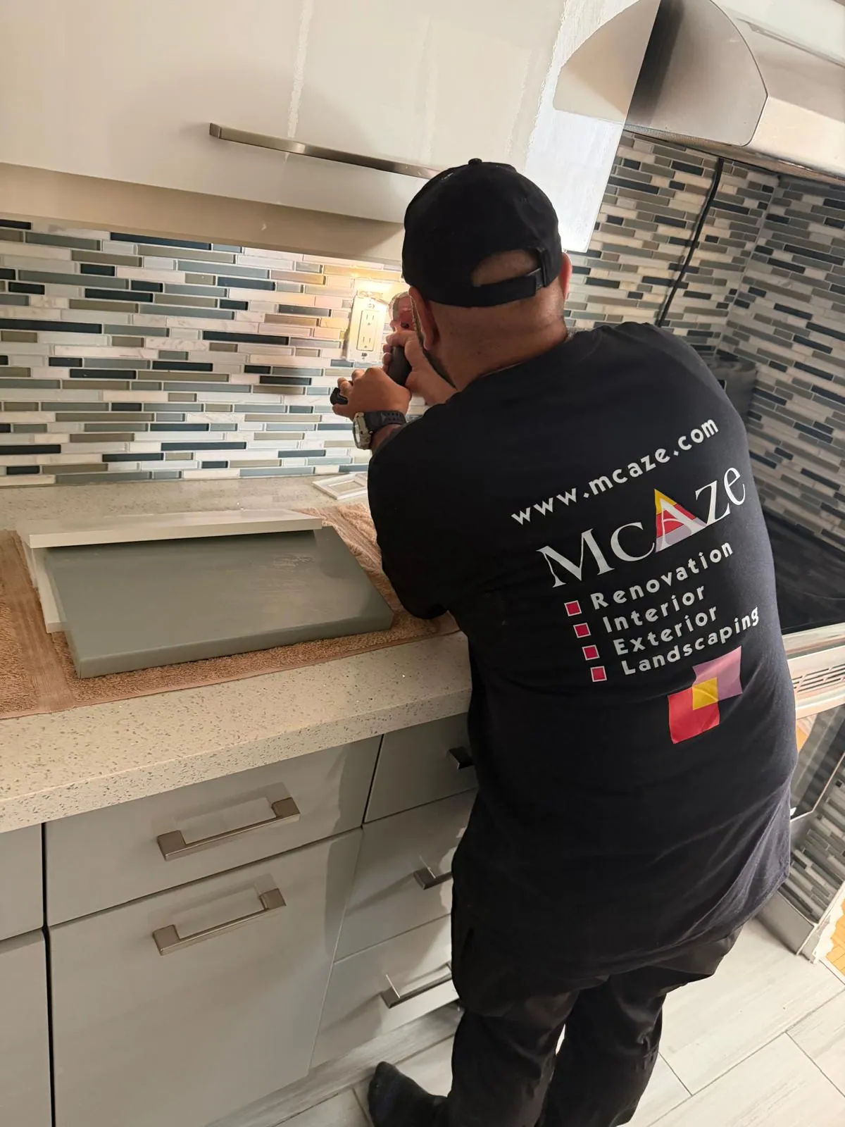 Kitchen outlet installation against mosaic backsplash in North York
