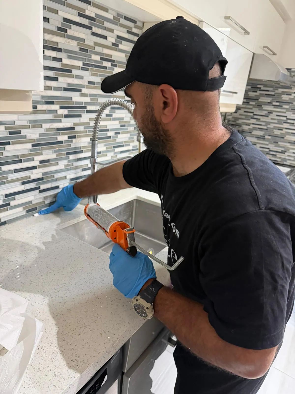 Kitchen sink silicone caulking during North York condo renovation