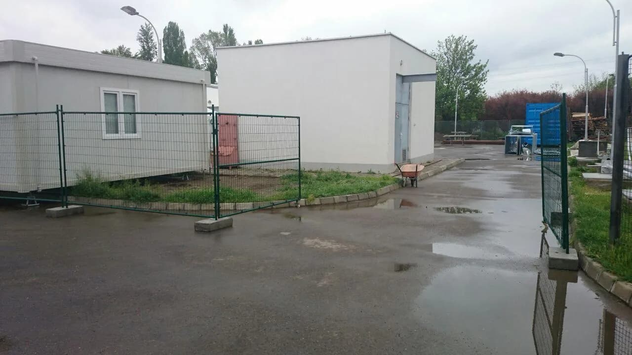 Temporary competition site office with steel platform and guarded stairs