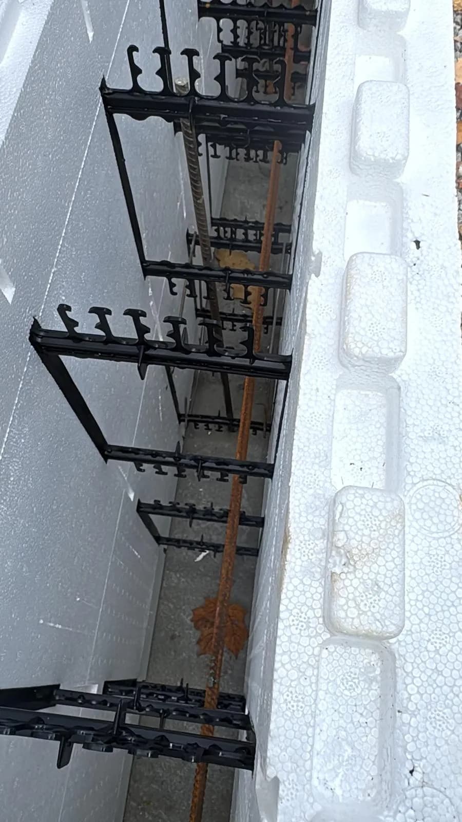 Steel reinforcement and plastic supports inside insulated concrete forms