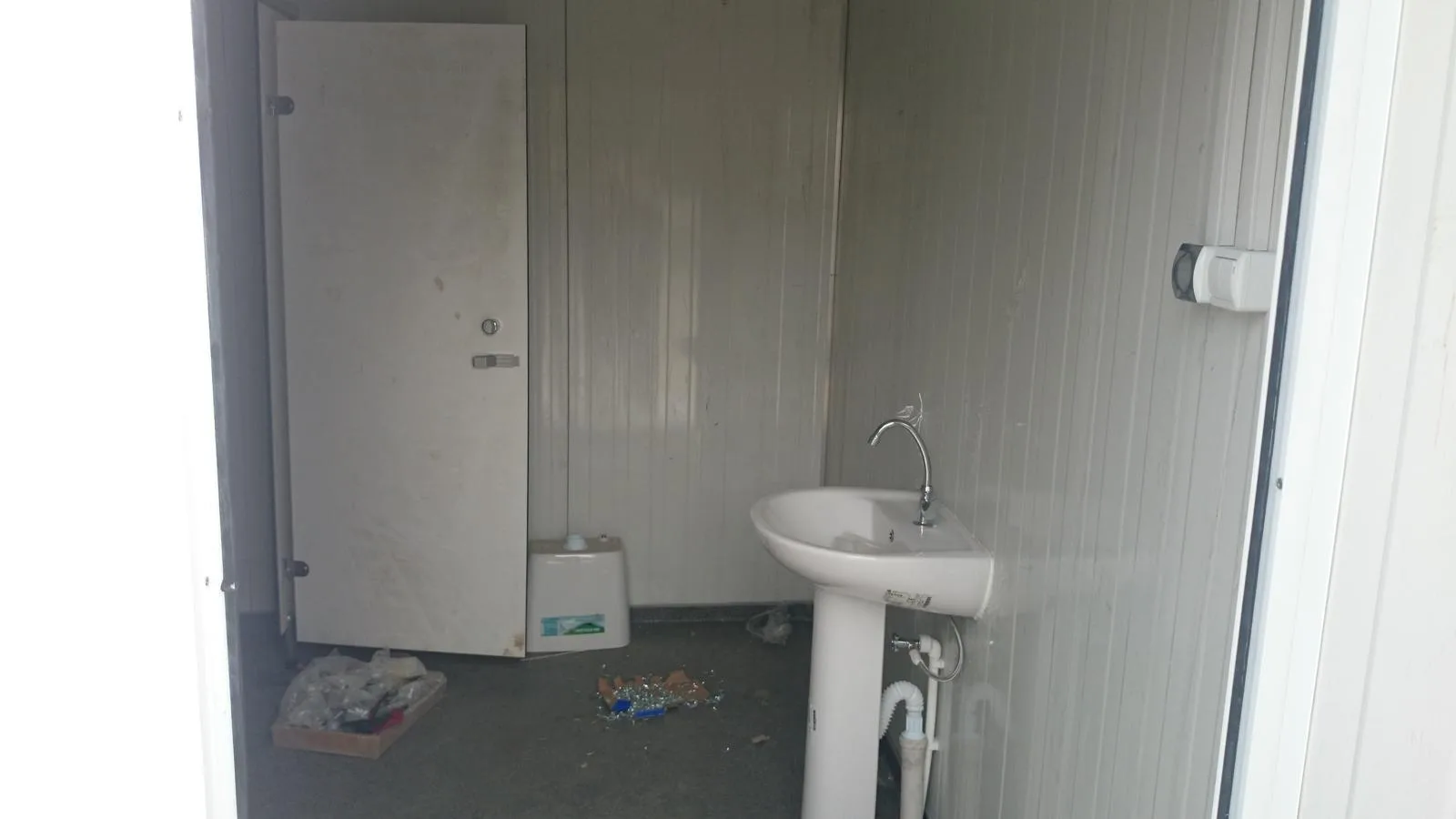 Temporary modular washroom interior during final fixture installation