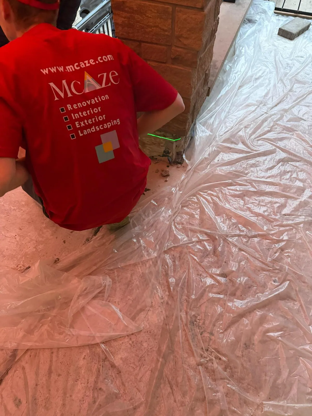 McAze inspecting bathroom floor before complete GTA renovation