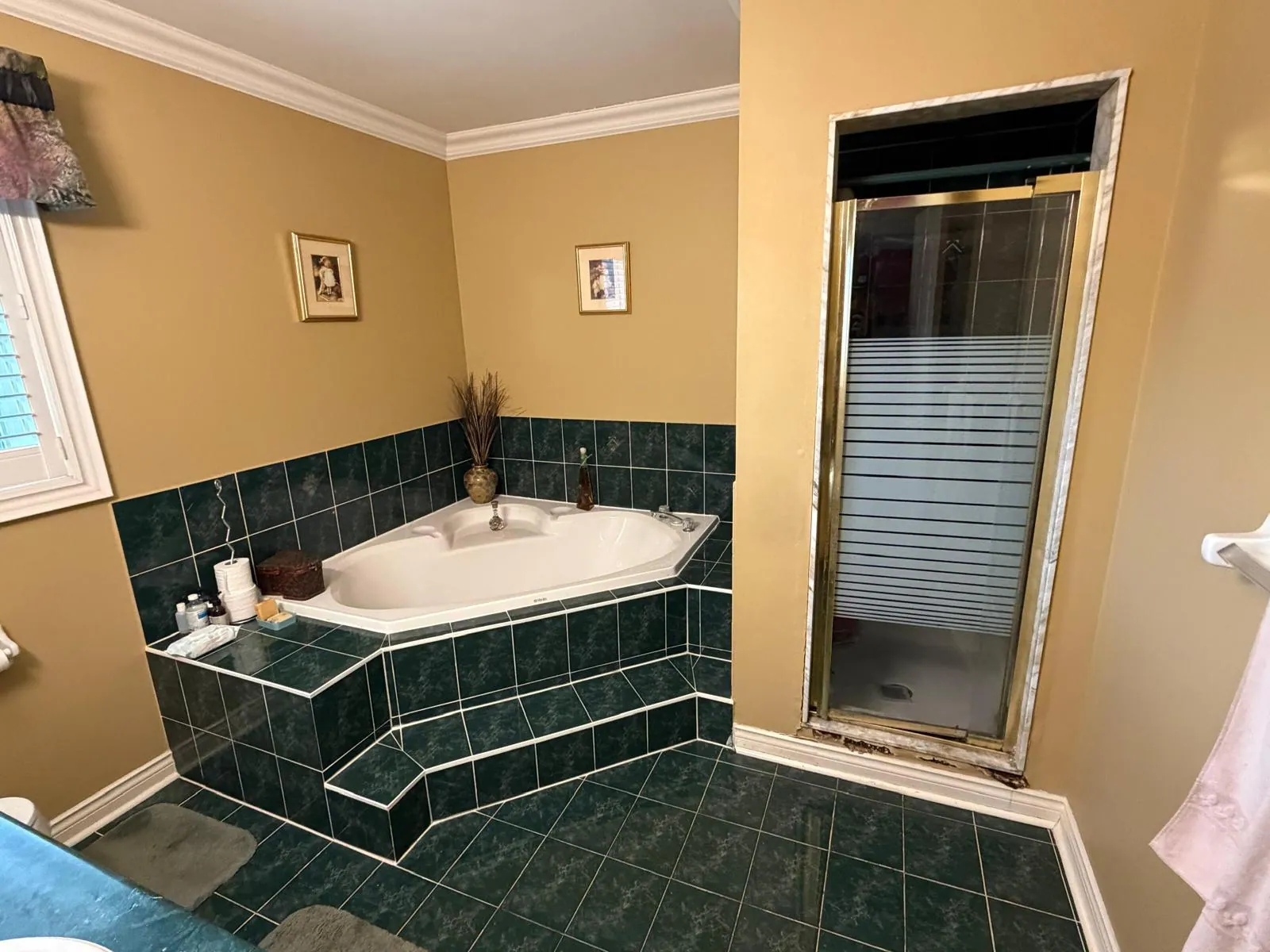 Existing tiled corner bathtub before bathroom renovation in Ontario