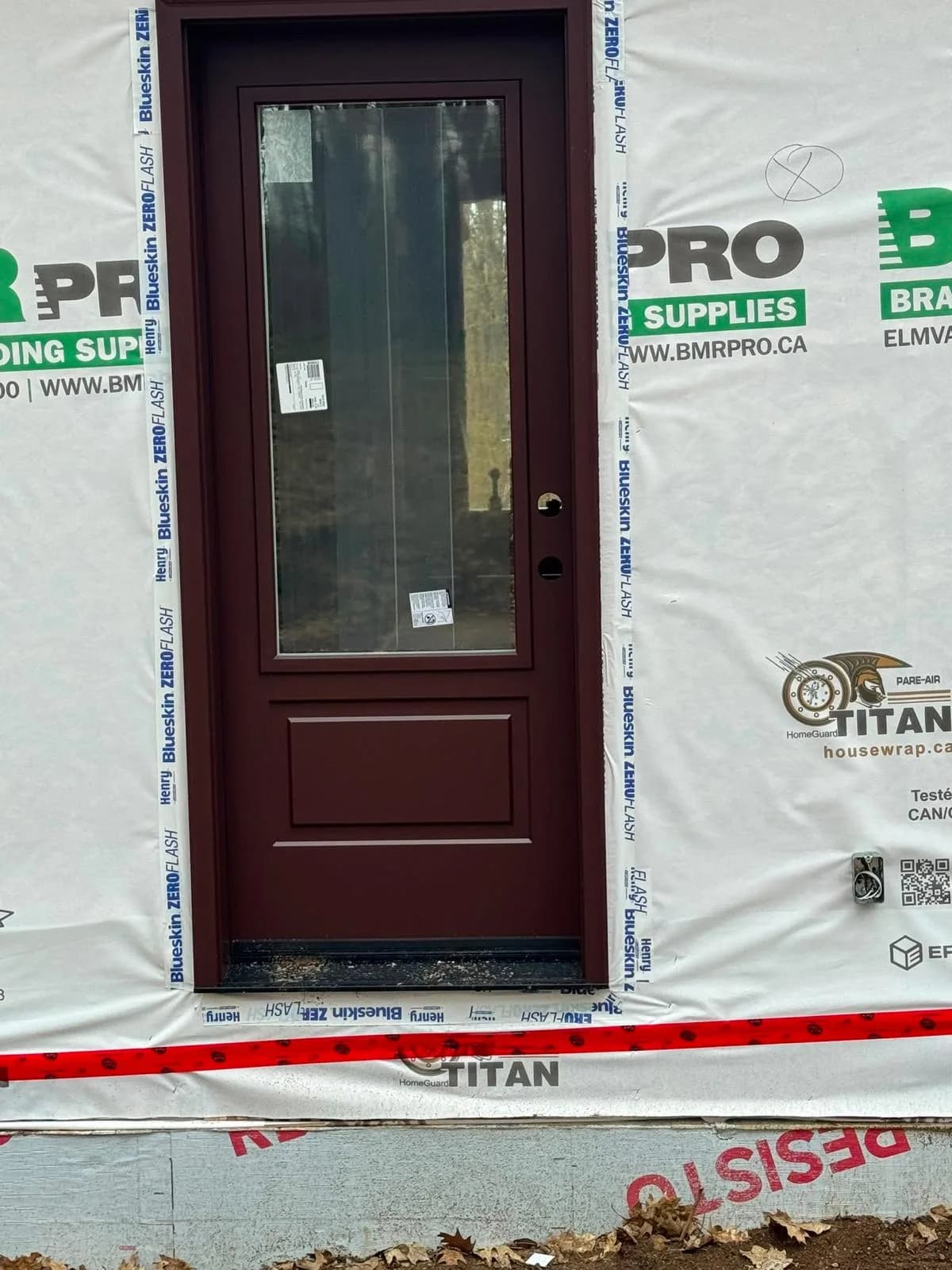 Glazed exterior entrance door installed with perimeter flashing in Markham