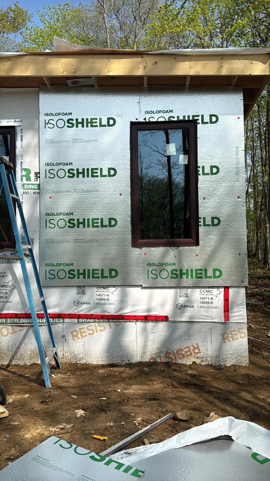 Tall dark-framed window installed beside rigid exterior insulation in Markham