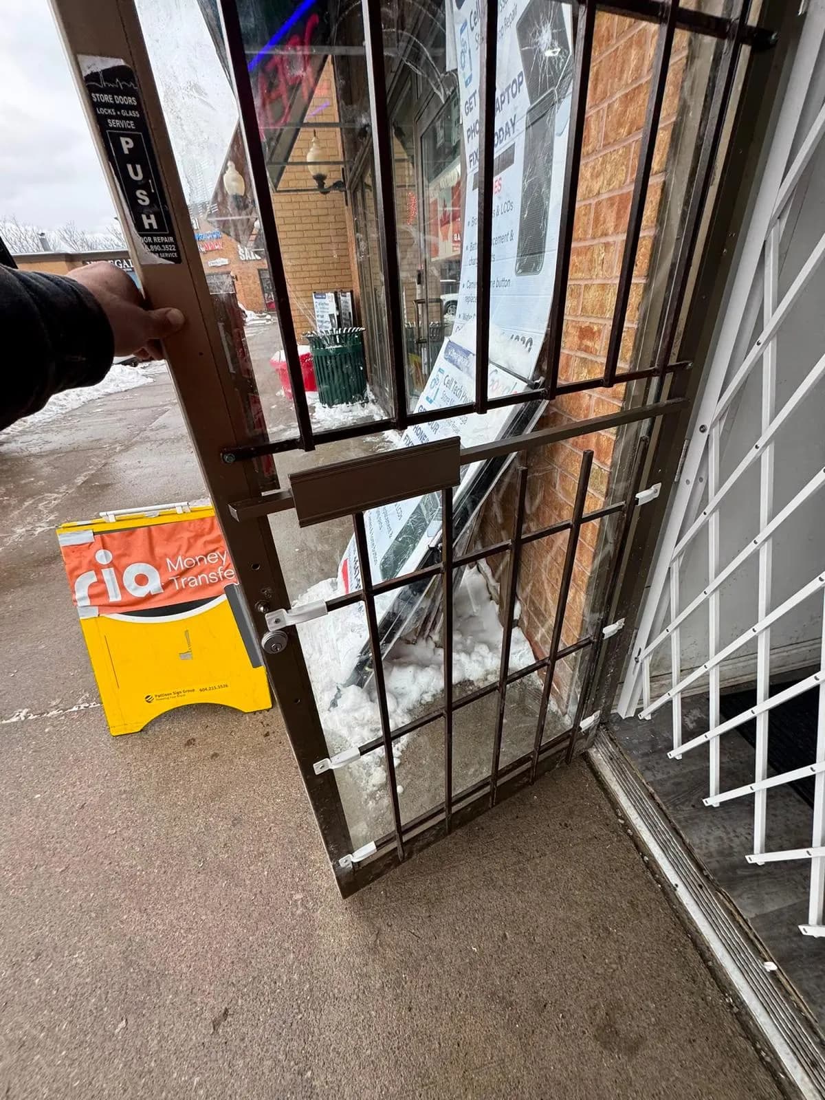 Existing storefront security door at a Mississauga commercial entrance