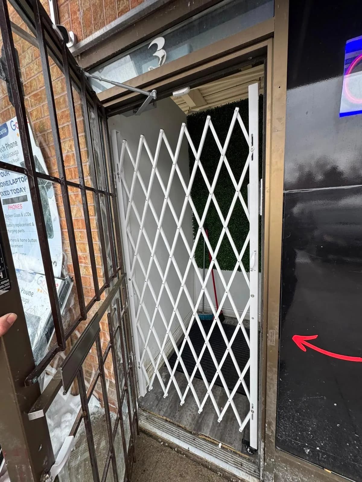 Expandable security gate installed at a Mississauga storefront entrance