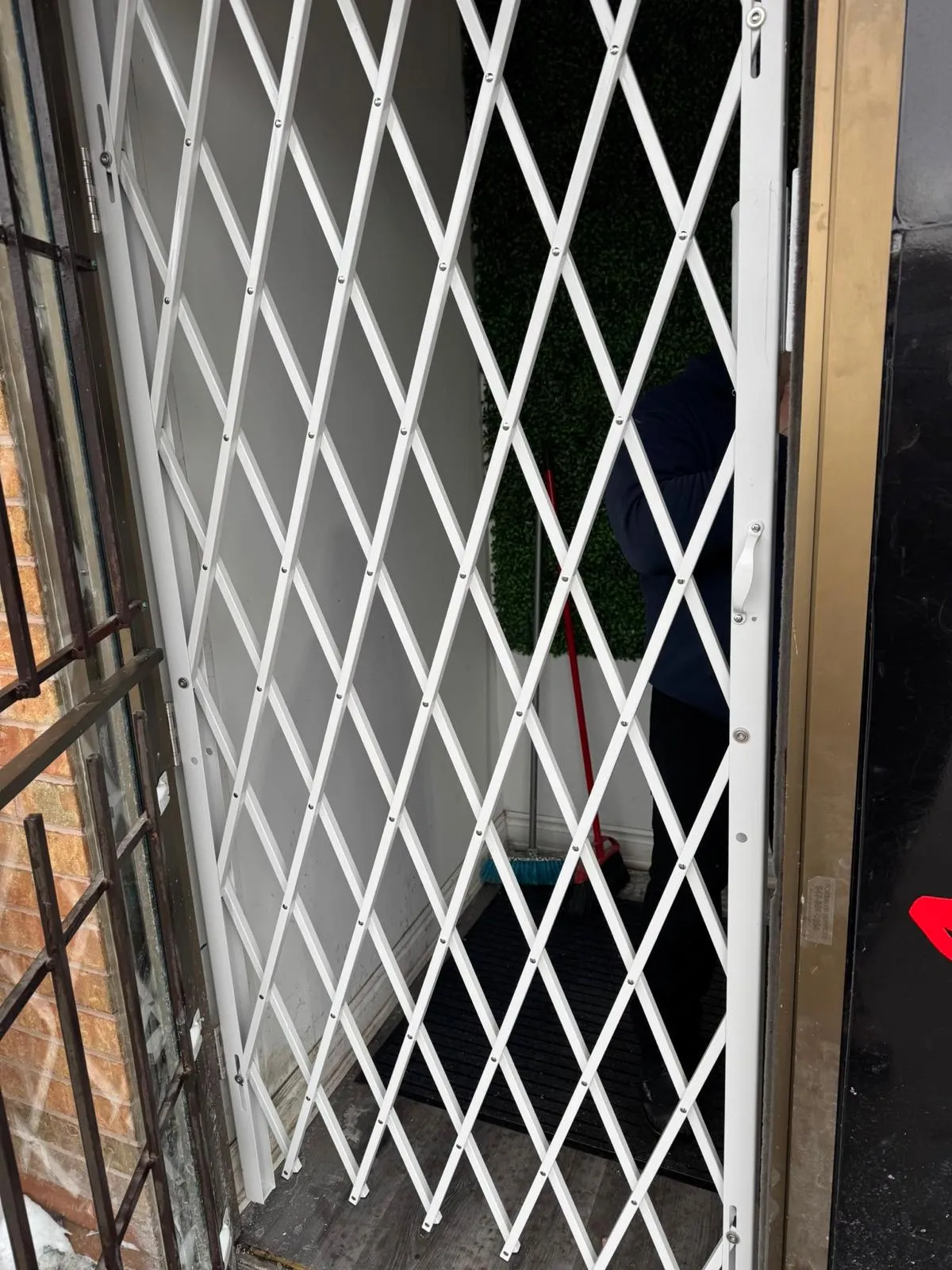 Installed white expandable commercial security gate in Mississauga
