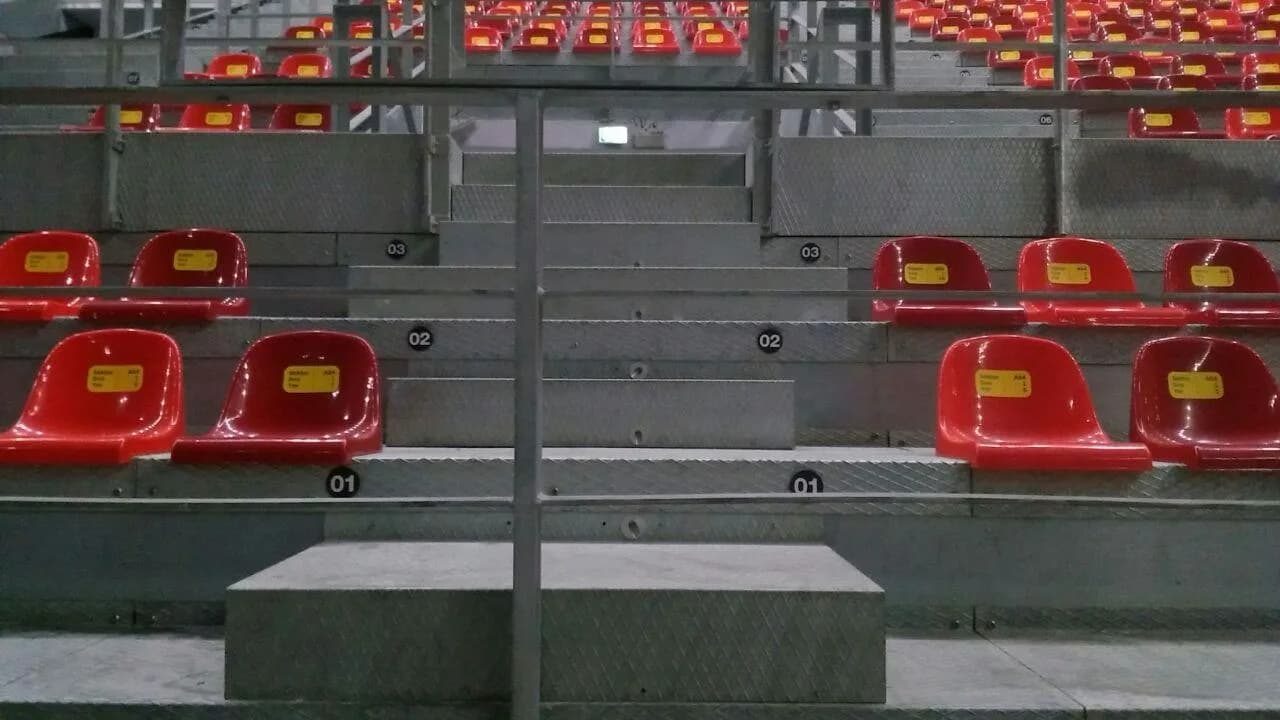 Numbered rows and aluminum stairs on a temporary competition seating structure
