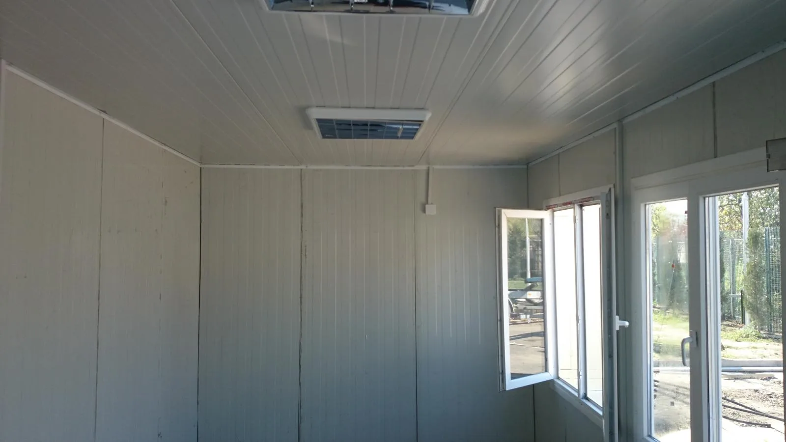 Interior of modular office with LED lighting and operable windows