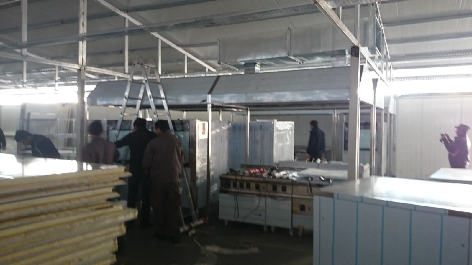 Commercial exhaust hood installed above fast food cooking line